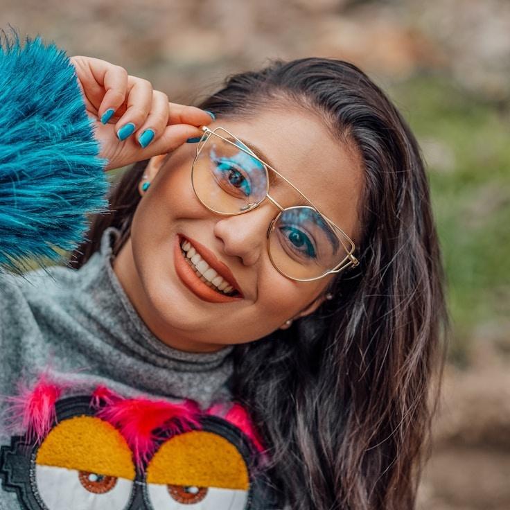 Kaveri Mehta, Lead Design Curator at PlainLawnFlint, reviewing corporate floral arrangements